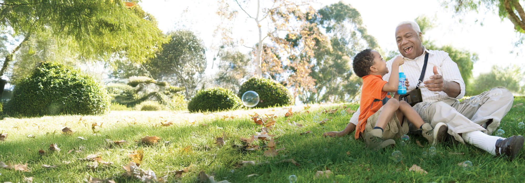 LifeVest wearable defibrillator patient and grandchild blow bubbles in a park