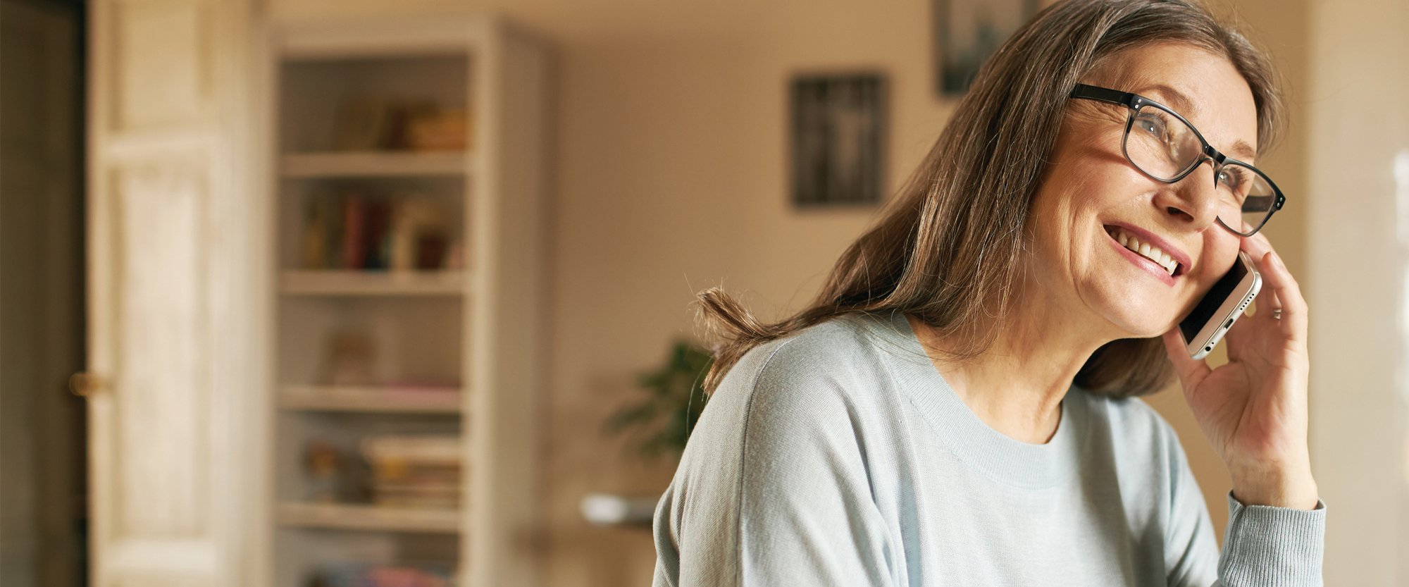 Woman smiling while on phone