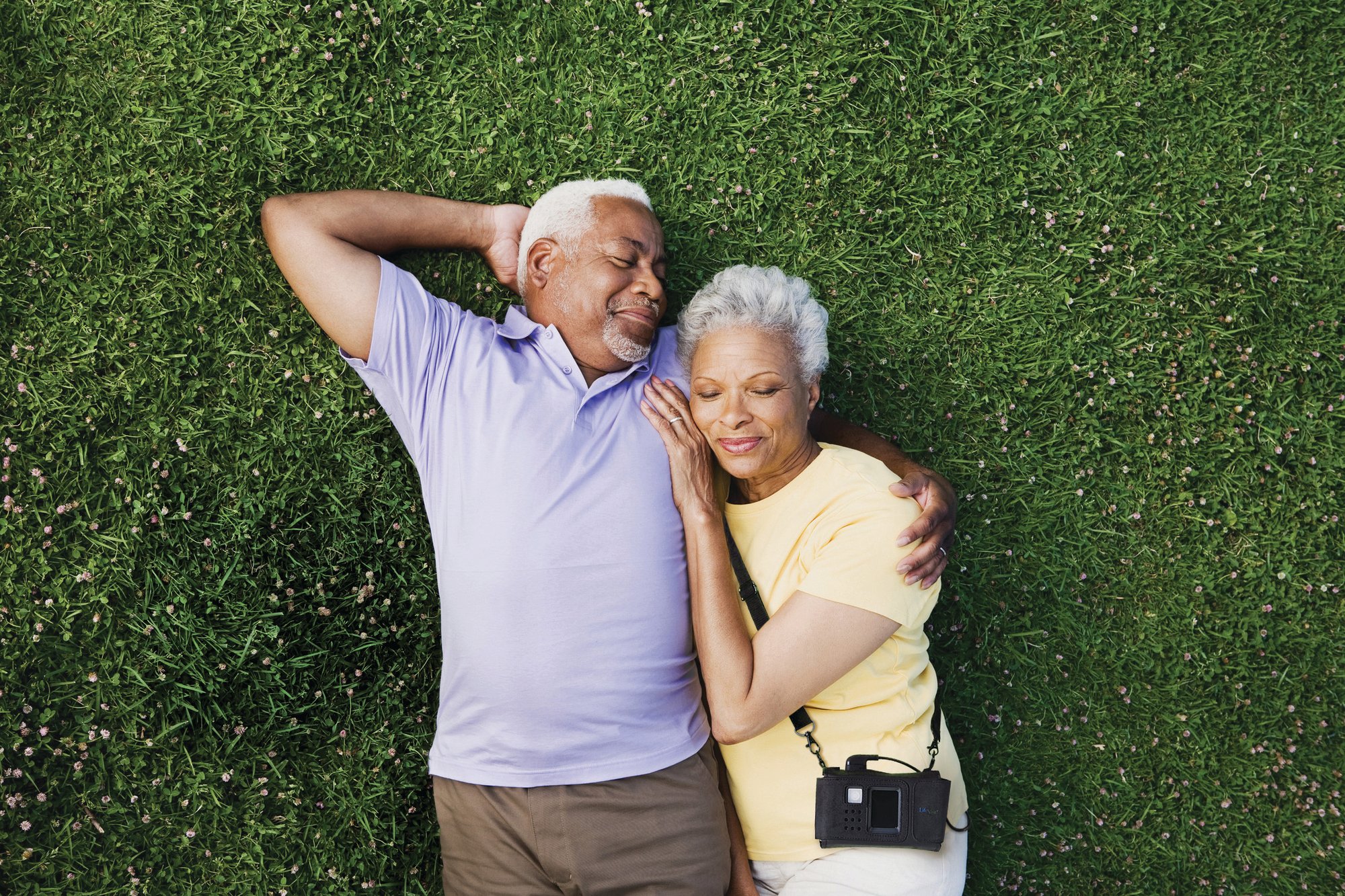 LifeVest wearable cardioverter defibrillator patient and spouse laying in grass