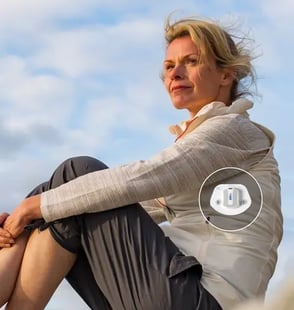 Woman sitting with illustration of HFMS on her left side.