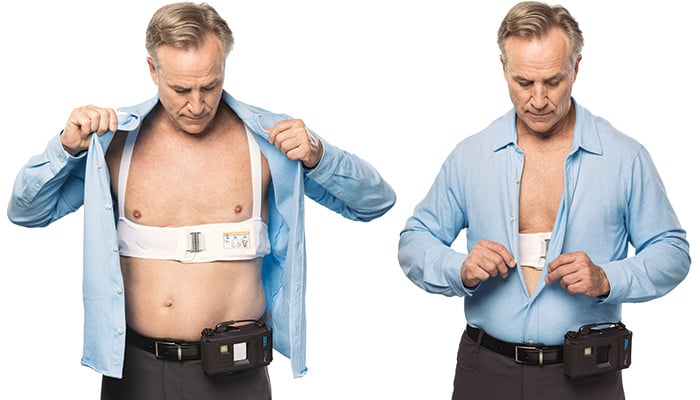 Man putting shirt over ZOLL LifeVest garment