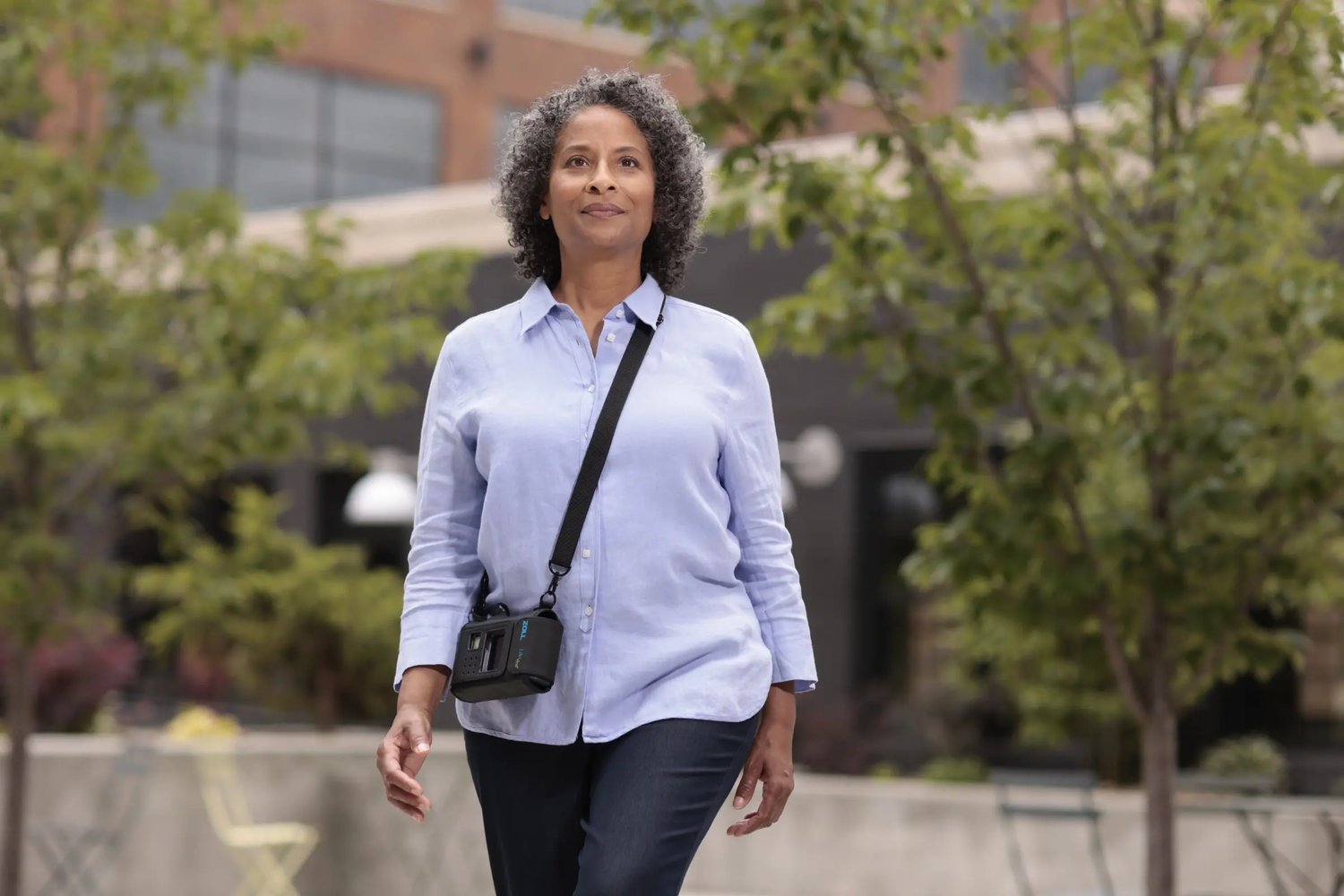 Woman walking outdoors wearing ZOLL LifeVest