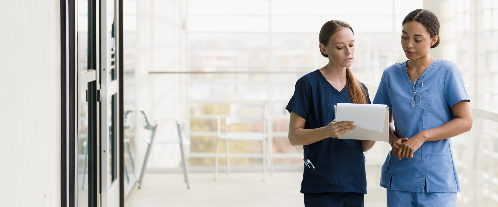 Female physicians reviewing a document in a hospital