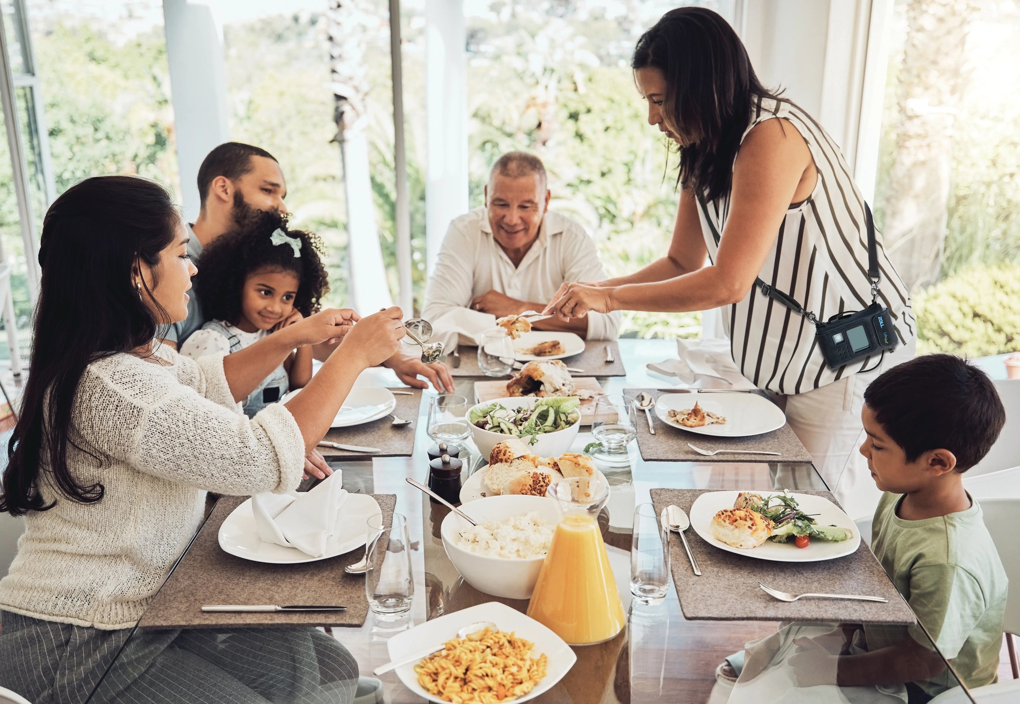 LifeVest wearable cardioverter defibrillator patient is serving dinner to a multi-generational family