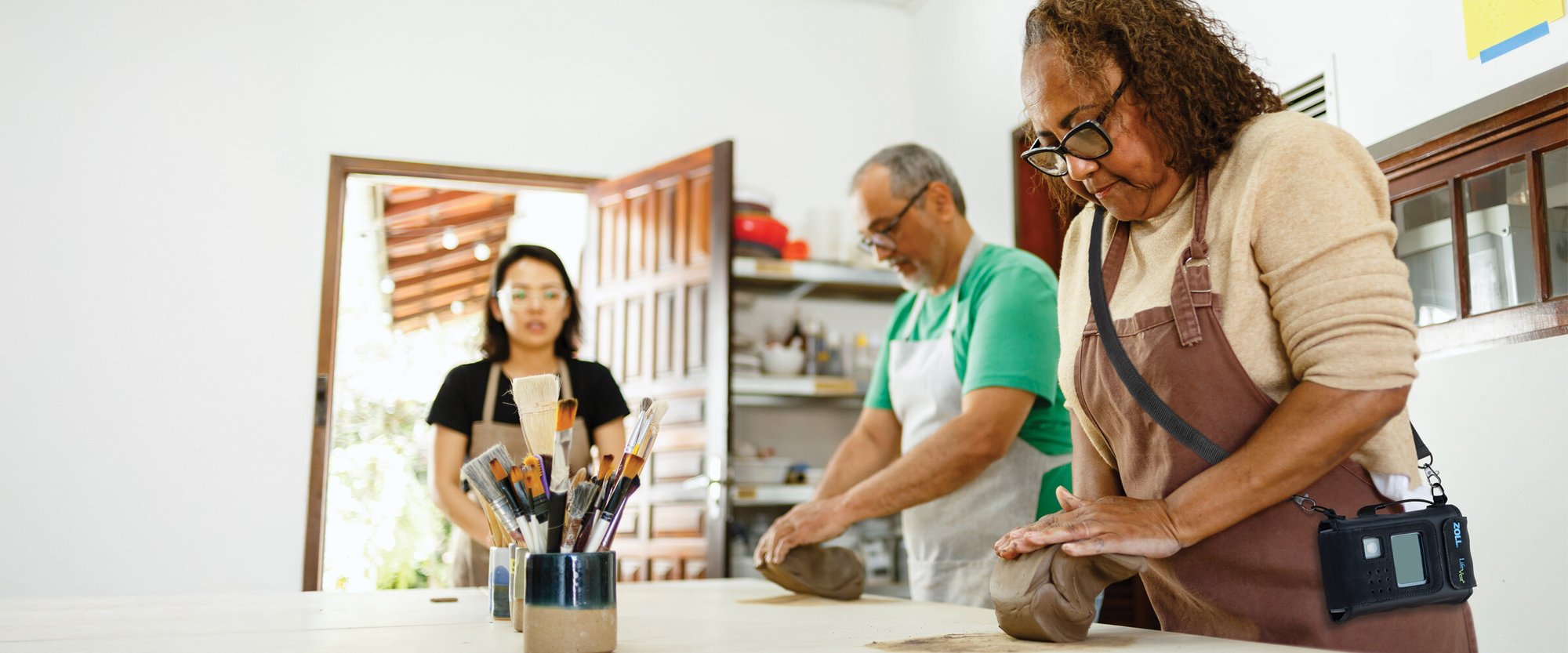 LifeVest patient molds clay during an art class