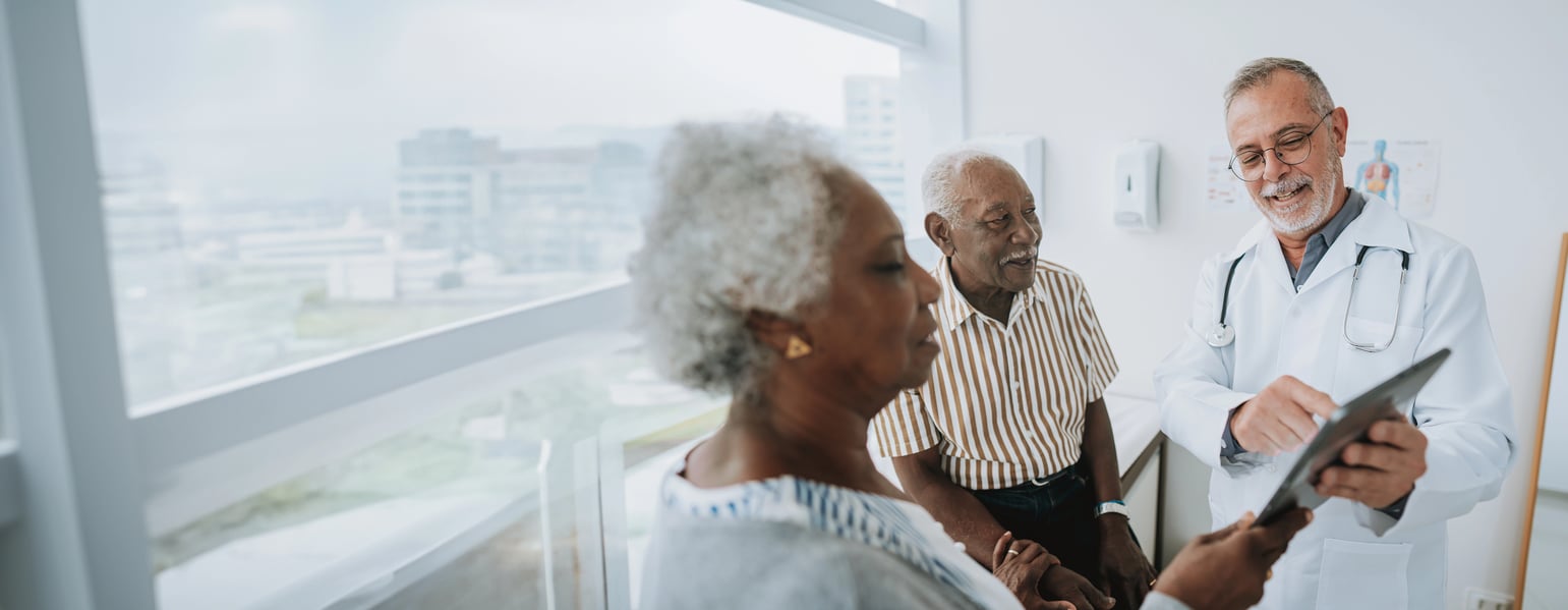 doctor reviewing data with a patient and spouse